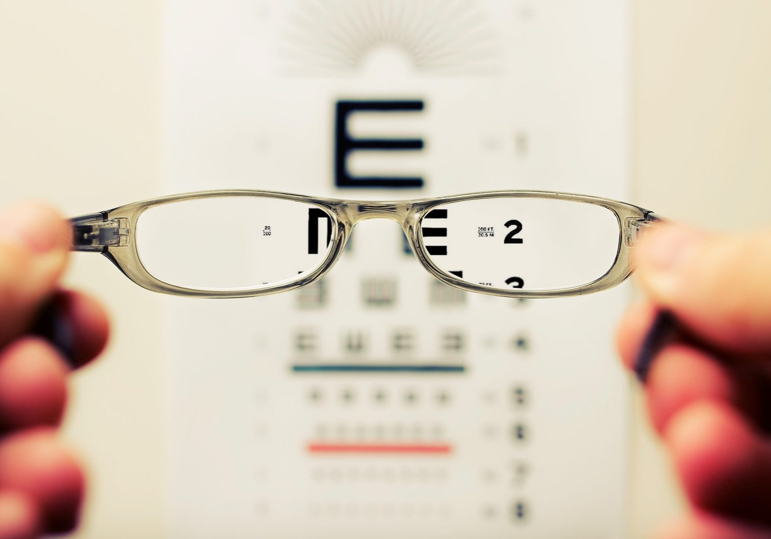 person holding eyeglasses